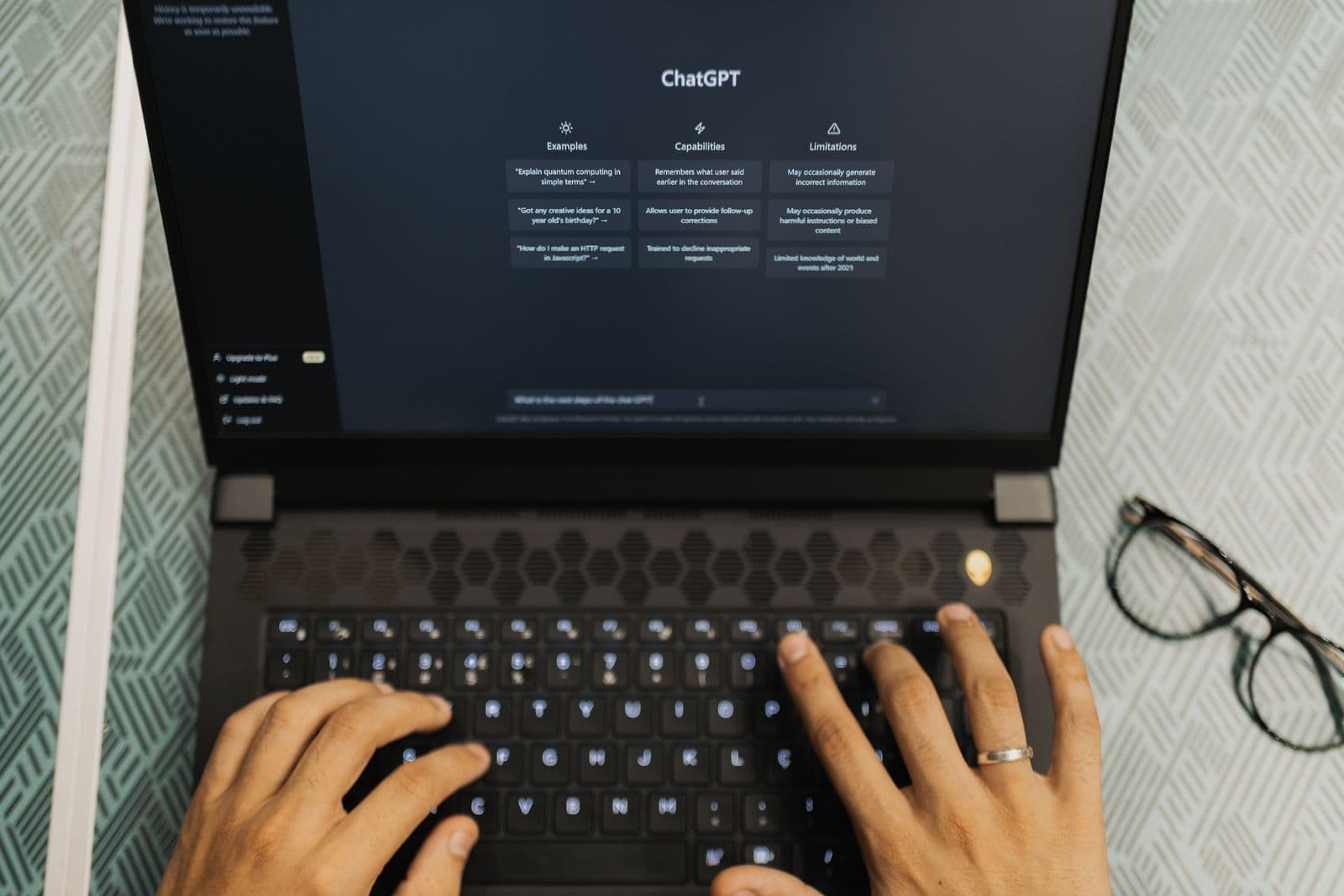 Researcher typing interview transcripts into ChatGPT on a laptop for AI-assisted qualitative analysis